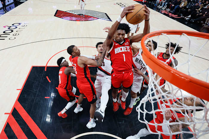 Rockets' Amen Thompson (1) comes down with a rebound next to Portland Trail Blazers forward Rayan Rupert (72) during the second half at Moda Center.